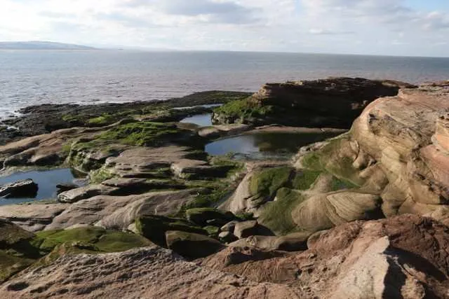 Rock pools and red sandstone on the edge of Hilbre, looking out to sea